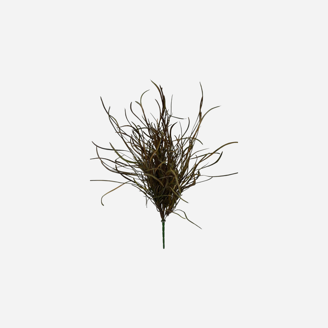 Branche décorative artificielle Maison Olive avec graminées aux nuances vert olive et brun cuivré sur fond brique