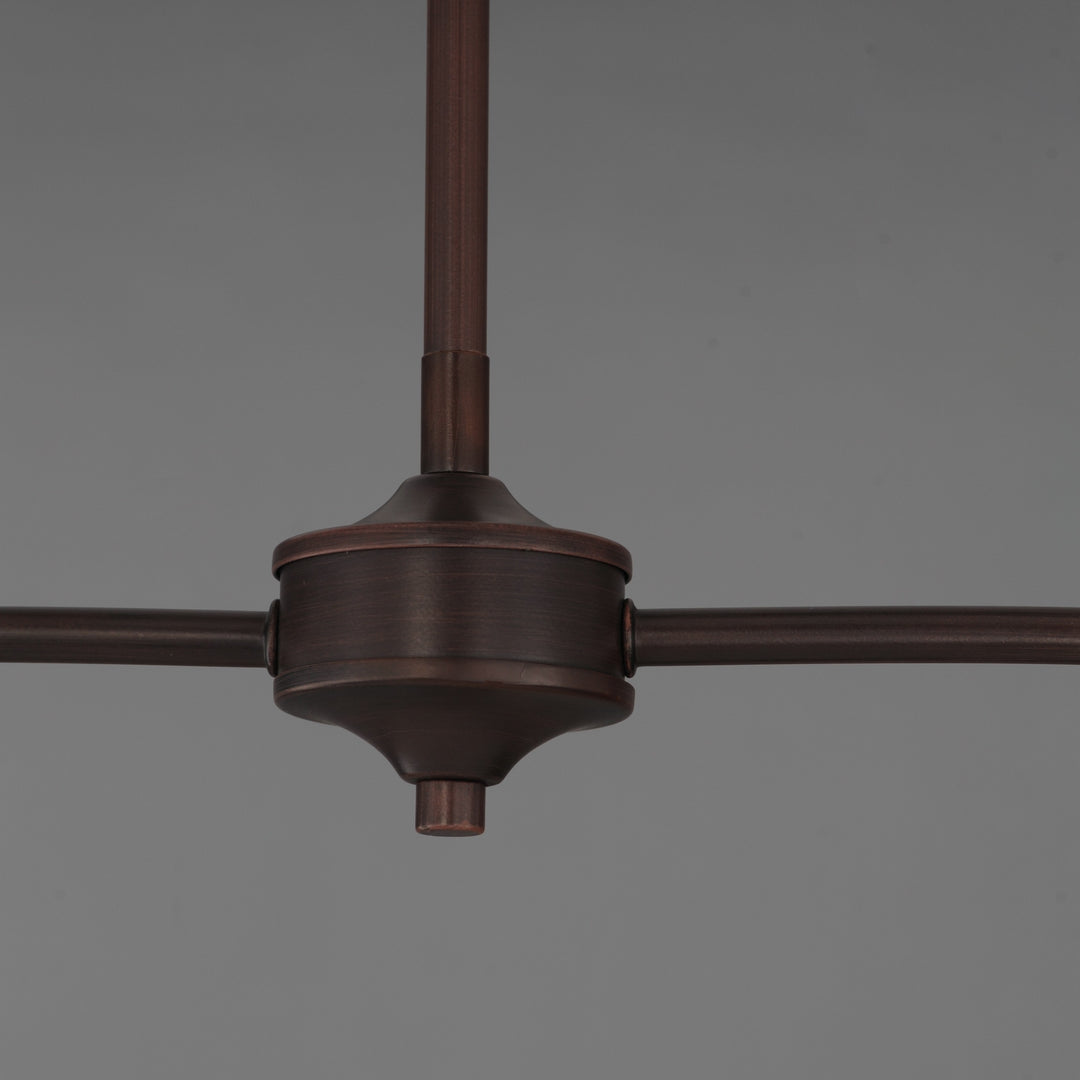 Détail central d'un luminaire Maison Olive en métal bronze foncé avec bras horizontaux et tige verticale
