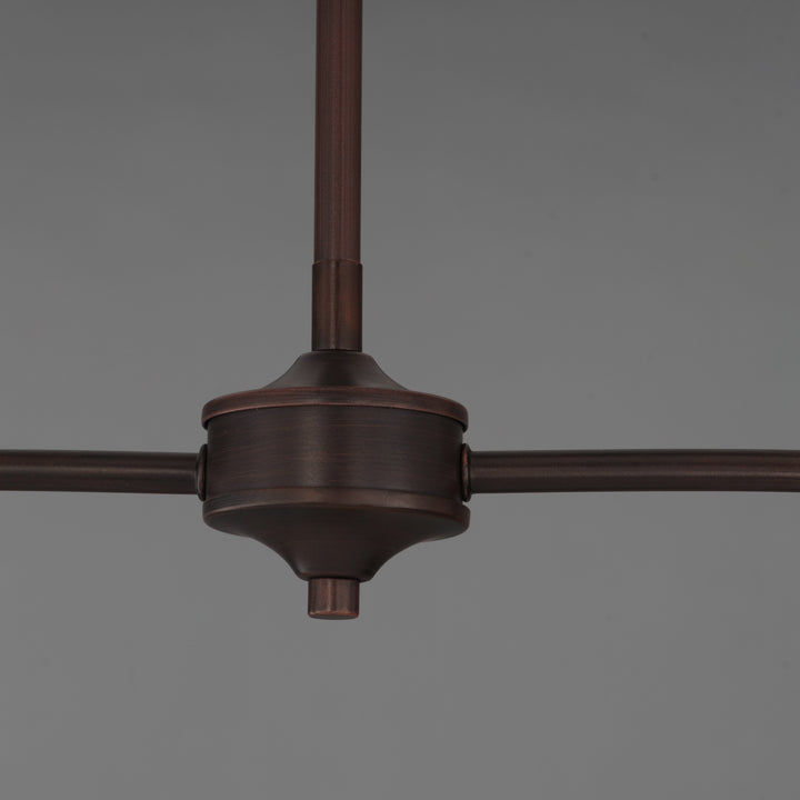 Détail central d'un luminaire Maison Olive en métal bronze foncé avec bras horizontaux et tige verticale