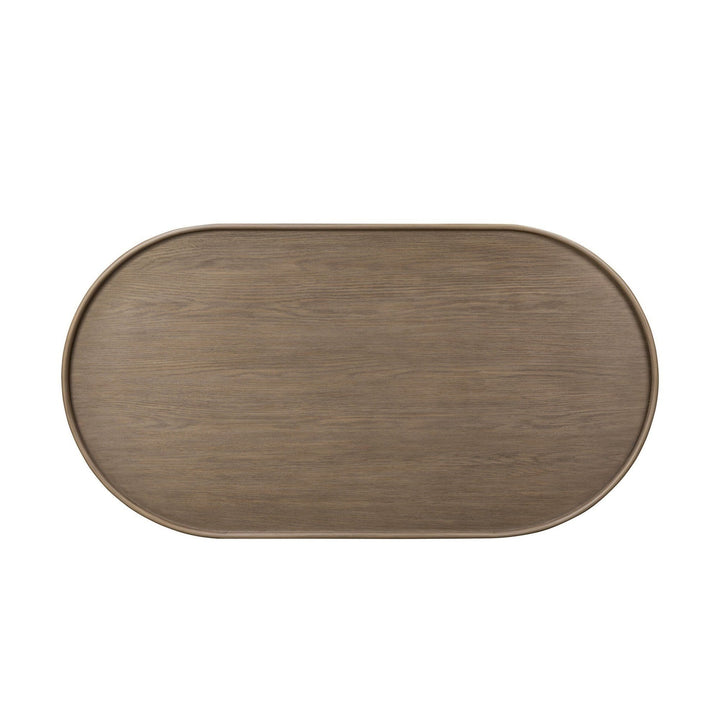 Maison Olive table basse ovale en bois naturel avec finition subtile mettant en valeur les veinures riches. Design épuré et organique.