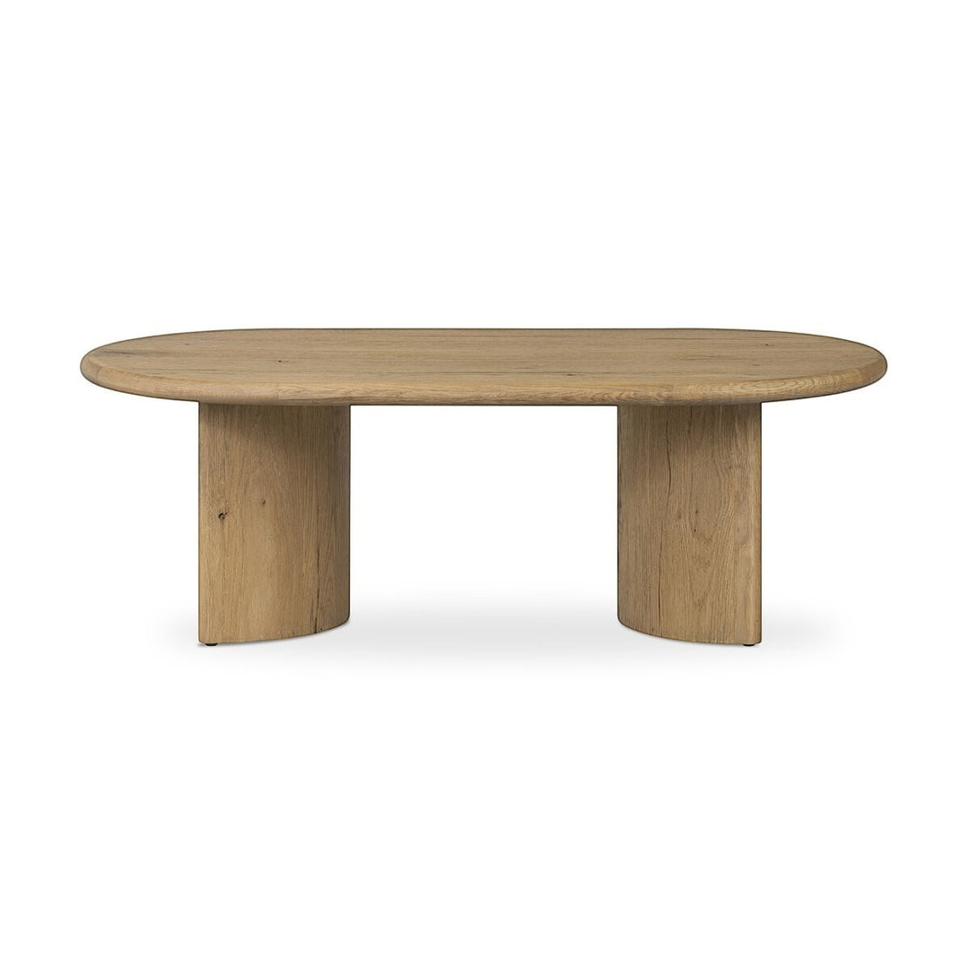 Maison Olive Table basse PADEN en chêne naturel clair, plateau ovale et pieds en forme de croissant.