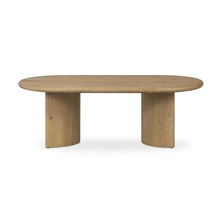 Maison Olive Table basse PADEN en chêne naturel clair, plateau ovale et pieds en forme de croissant.