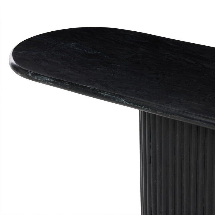 Maison Olive Table basse ovale en marbre noir veiné avec pied cannelé noir