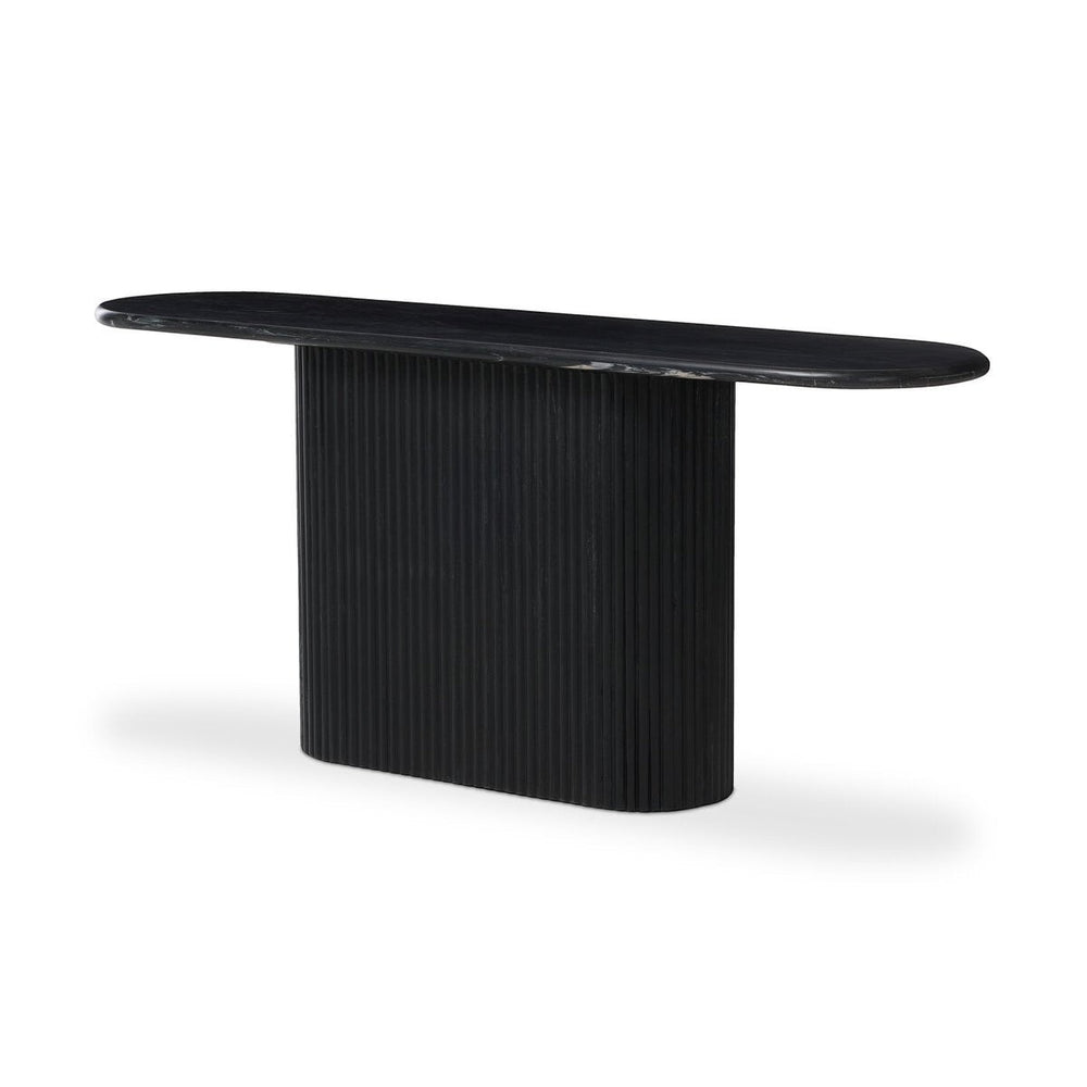 Maison Olive Table basse ovale en marbre noir veiné avec pied cylindrique cannelé noir.