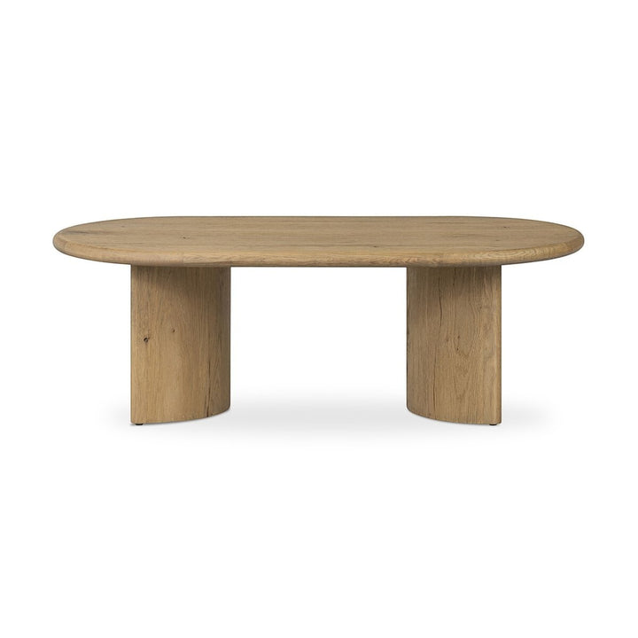 Maison Olive Table basse PADEN en chêne naturel clair, plateau ovale et pieds incurvés organiques.