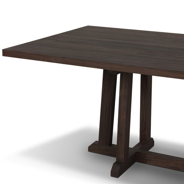 Maison Olive table à manger en bois massif foncé avec pieds croisés en H, plateau à lattes espacées, style campagnard moderne.