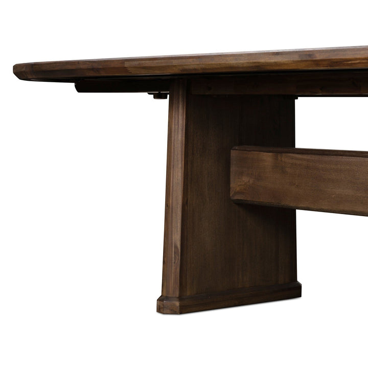 Maison Olive table à manger rustique en bois brun foncé avec piètement pedestal. Finition naturelle.