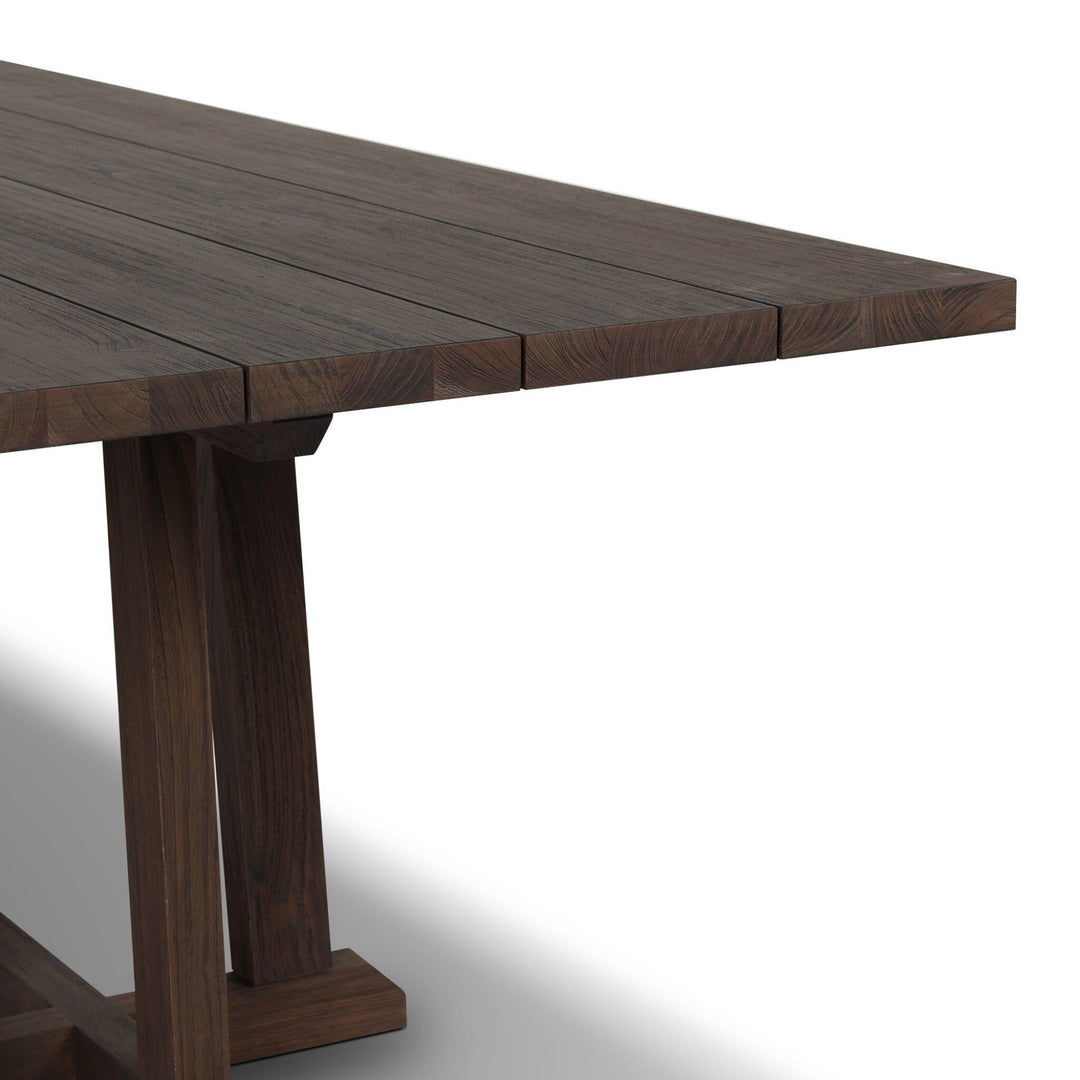 Maison Olive table à manger en bois de teck foncé avec pieds croisés en H, style rustique moderne.