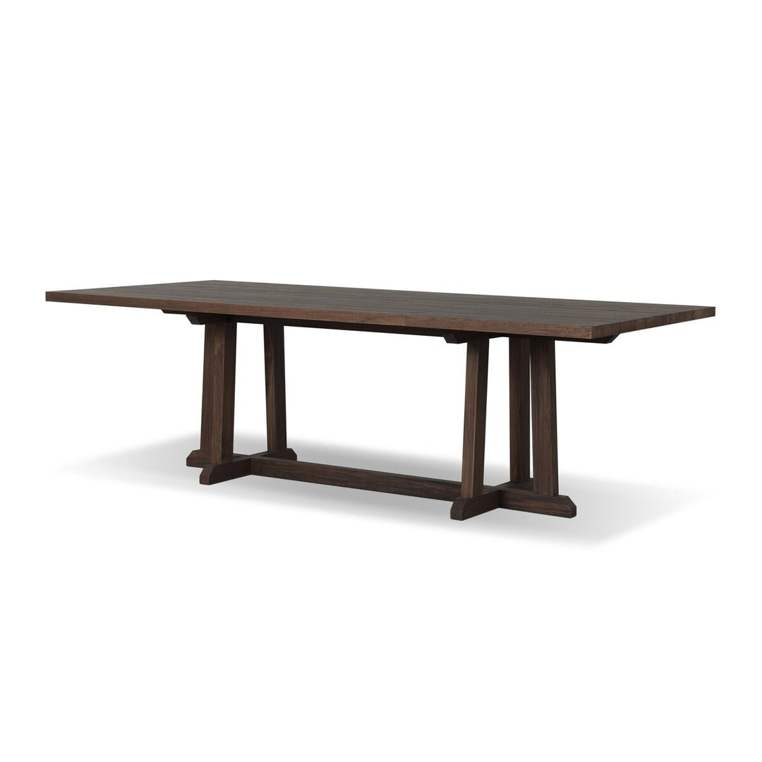Maison Olive table à manger en bois de teck foncé avec pieds croisés en H, style rustique moderne.