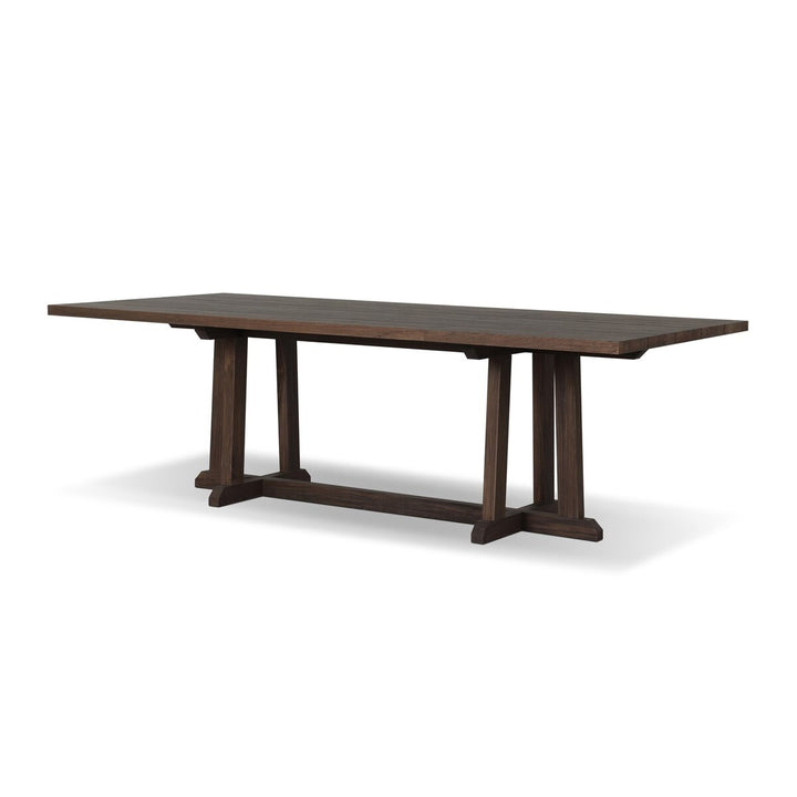 Maison Olive table à manger en bois de teck foncé avec pieds croisés en H, style rustique moderne.