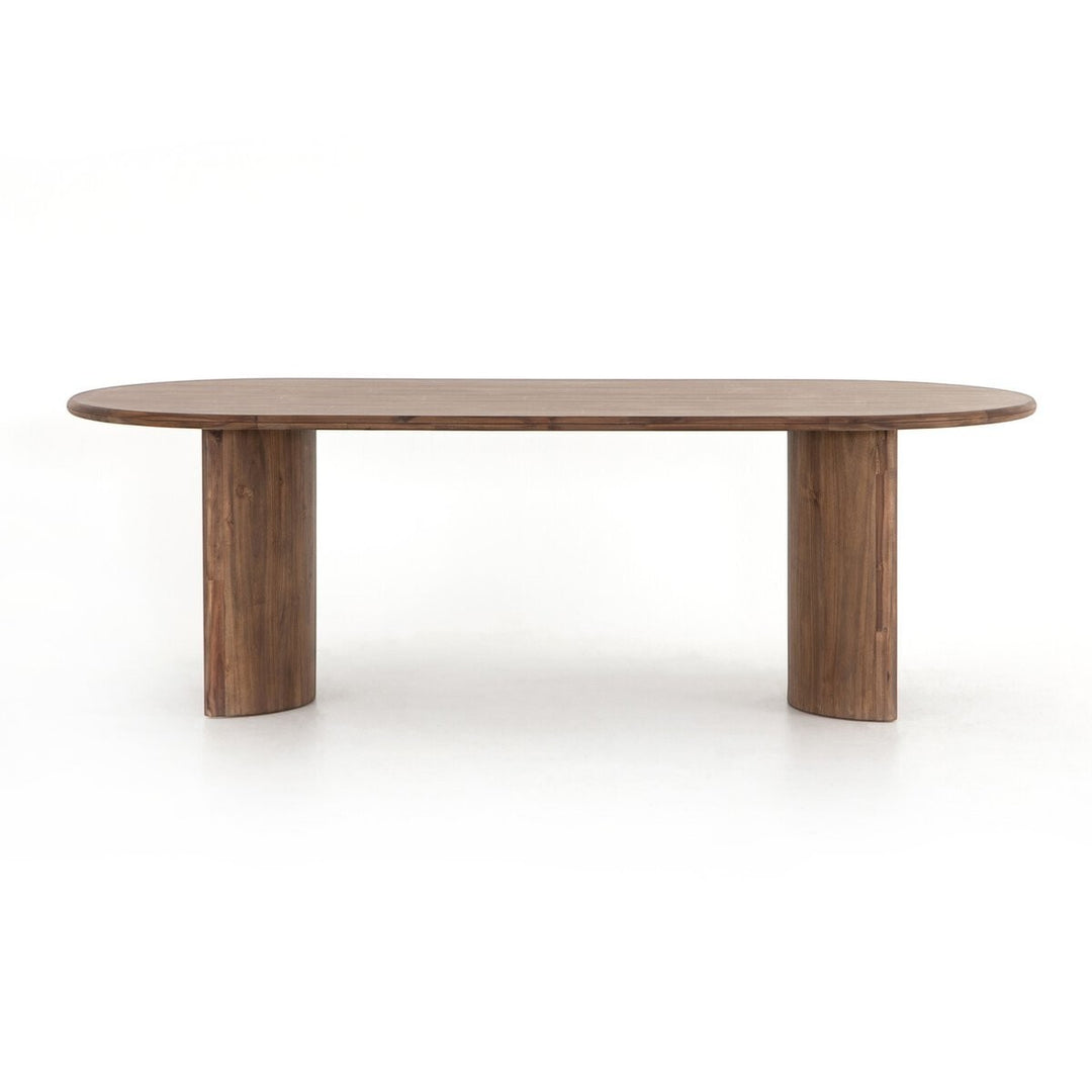 Maison Olive Table à manger ovale en bois d'acacia noir vieilli avec piétement cylindrique sculptural.