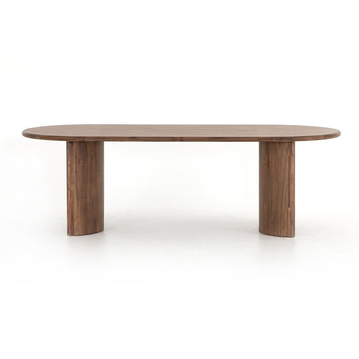Maison Olive Table à manger ovale en bois d'acacia noir vieilli avec piétement cylindrique sculptural.