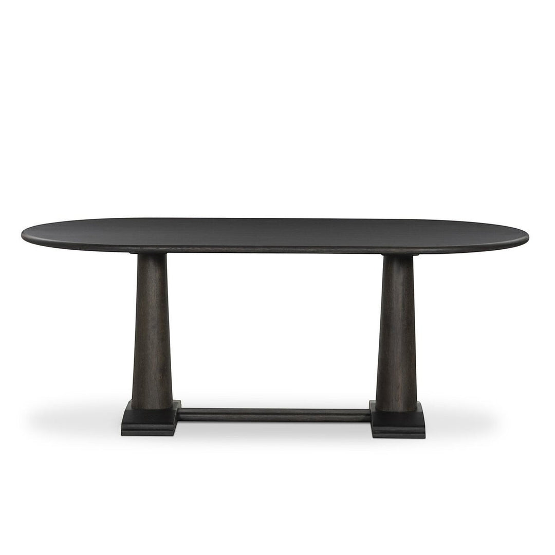Table à manger ovale en bois foncé Maison Olive avec piédestal central et grain de bois subtil.