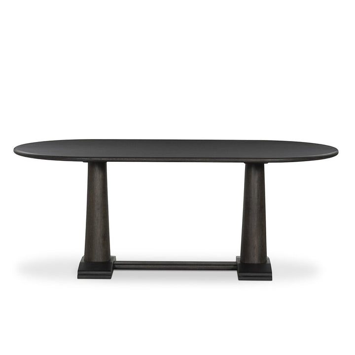 Table à manger ovale en bois foncé Maison Olive avec piédestal central et grain de bois subtil.