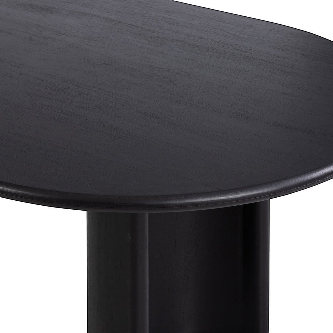 Table à manger ovale en bois noir Maison Olive avec piétement cylindrique, design moderne et épuré.