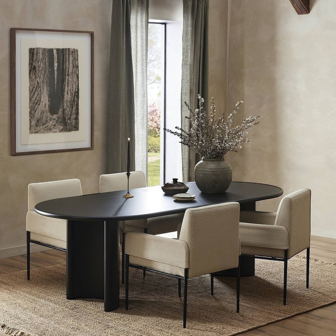 Maison Olive table à manger ovale en bois noir avec piétement cylindrique, design moderne.