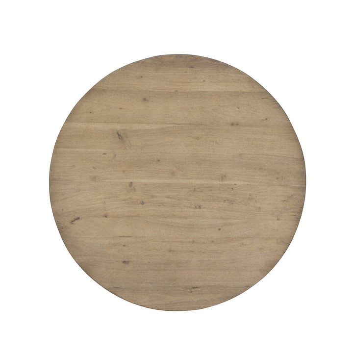 Maison Olive Table ronde en bois naturel avec plateau circulaire et grain visible, finition légèrement vieillie.