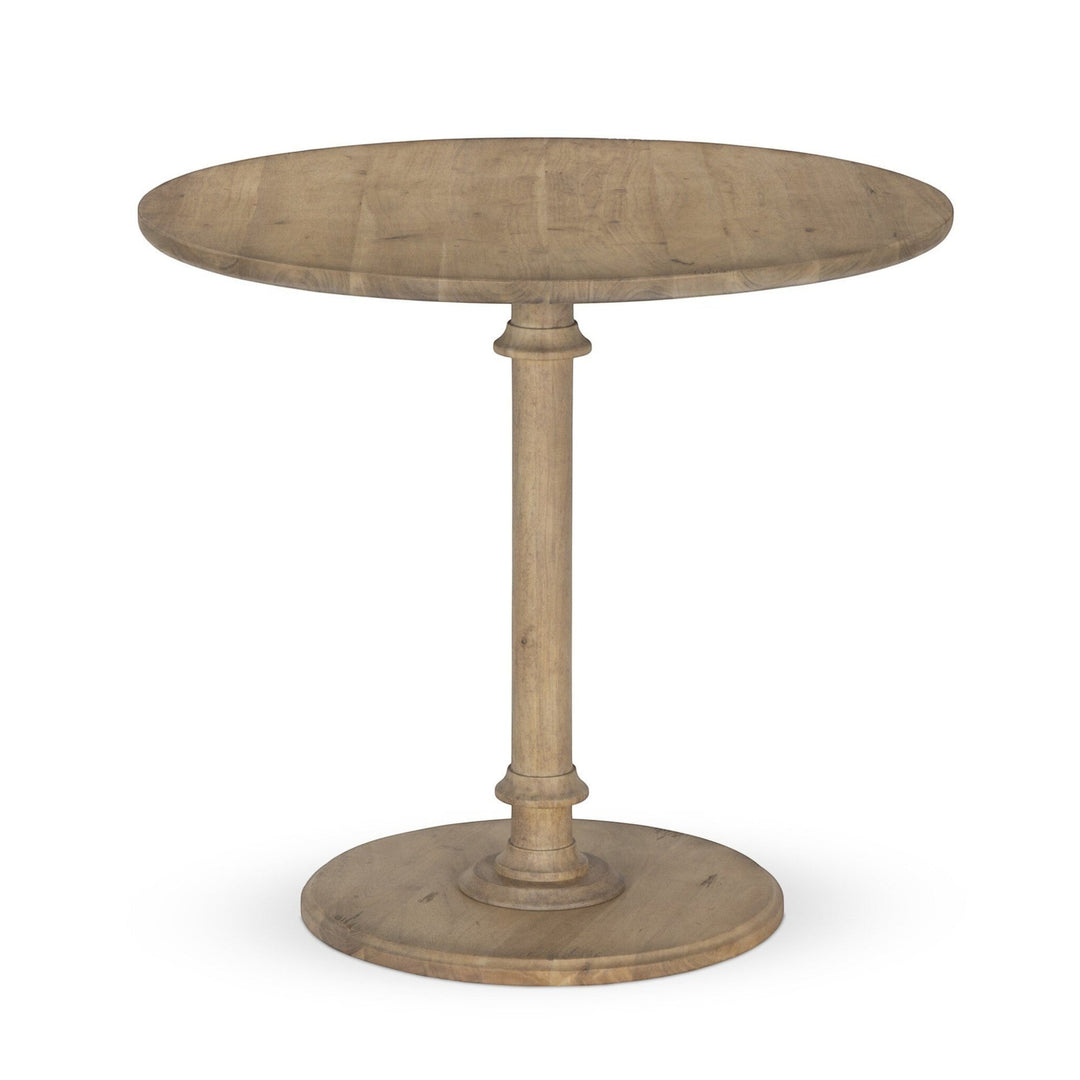 Maison Olive Table ronde en bois naturel avec pied central et base circulaire. Style rustique.