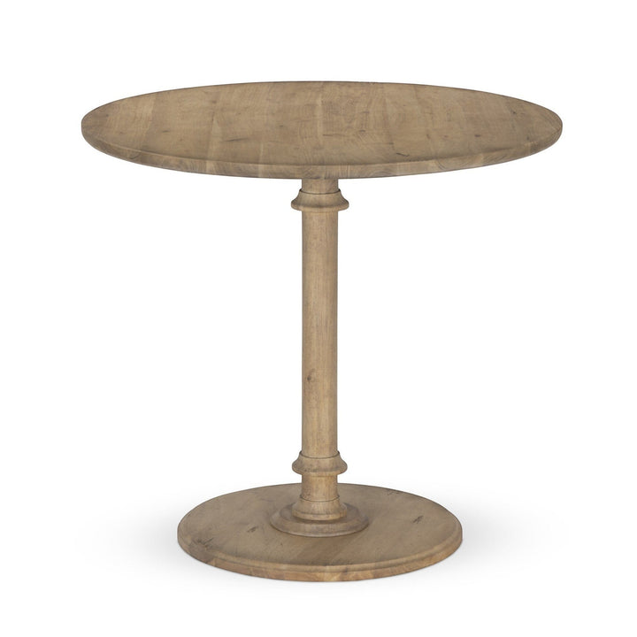 Maison Olive Table ronde en bois naturel avec pied central et base circulaire. Style rustique.