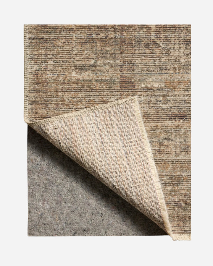 Tapis Maison Olive MOLLY aux tons tabac et sauge, tissé en polypropylène et polyester avec un coin replié