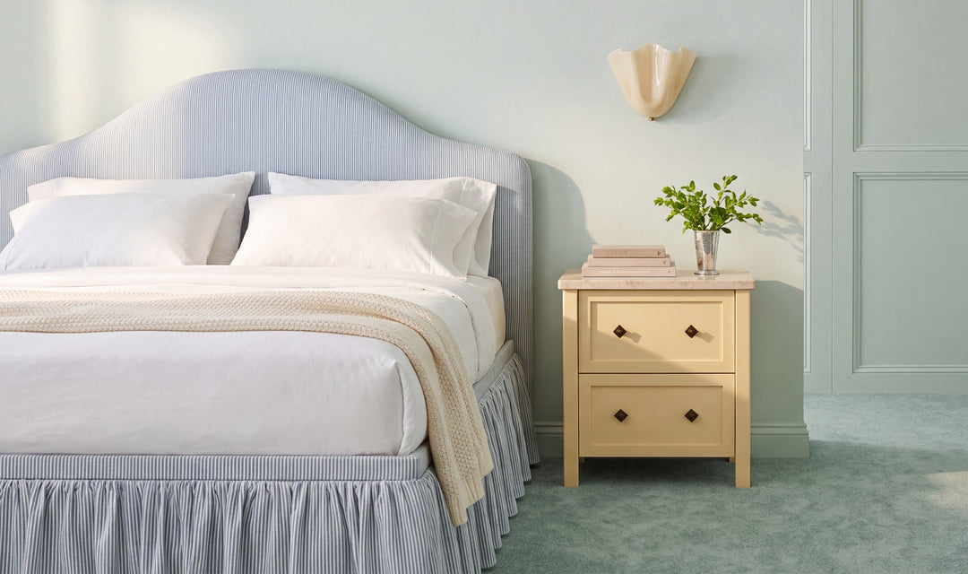 MATILDA butter yellow nightstand, in a bedroom beside a bed